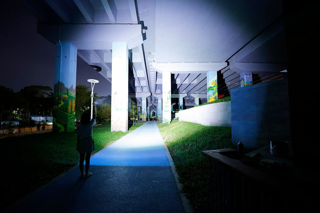 Should I use a flashlight when walking at night?
